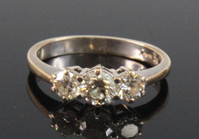 Lot 2519 - An 18ct white gold diamond three stone ring,...