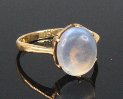 Lot 2521 - A yellow metal moonstone dress ring, the oval...