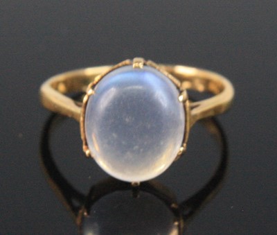 Lot 2521 - A yellow metal moonstone dress ring, the oval...