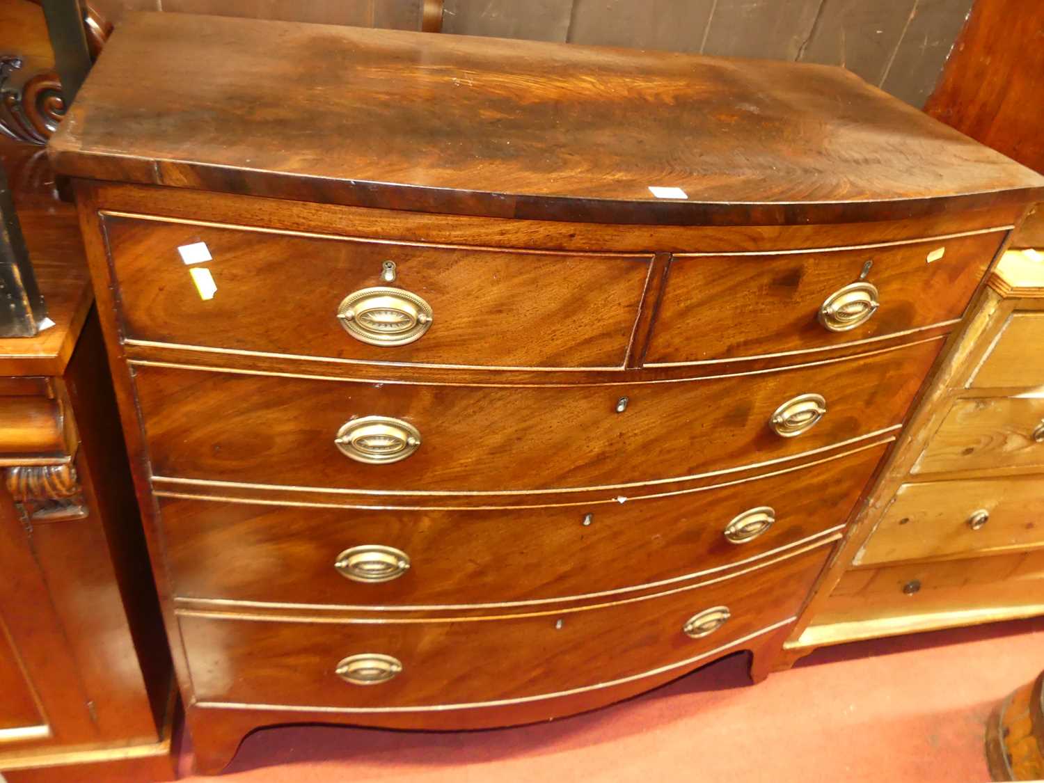 Lot 1324 - A Regency mahogany bowfront chest of two short...