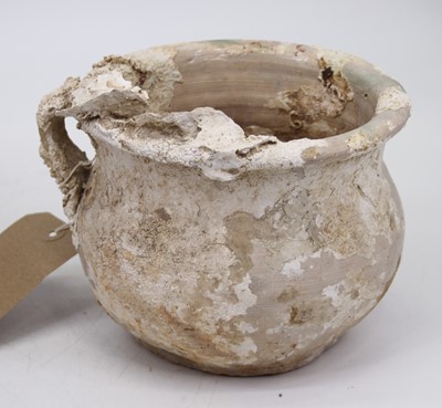 Lot 610 - A glazed earthenware pot, having a single loop...