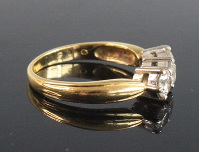 Lot 2535 - An 18ct yellow and white gold diamond trilogy...