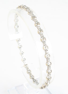 Lot 2541 - A white metal sapphire line bracelet,...