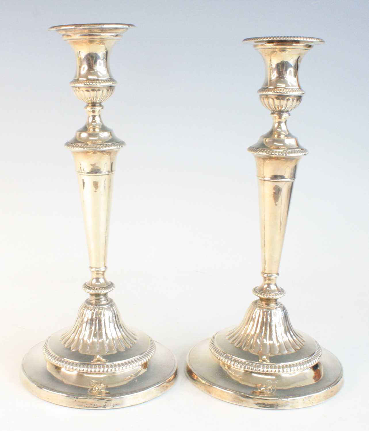 Lot 2098 - A pair of silver pedestal candlesticks on...