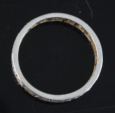 Lot 2570 - A white metal full hoop eternity ring,...