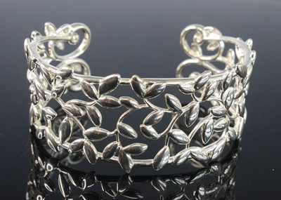 Lot 2582 - A Tiffany & Co silver 'olive leaf' bangle,...
