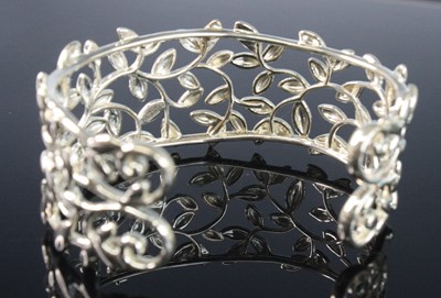 Lot 2582 - A Tiffany & Co silver 'olive leaf' bangle,...
