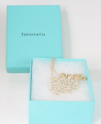 Lot 2583 - A Tiffany & Co silver 'olive leaf' pendant,...