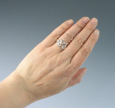 Lot 2585 - A Tiffany & Co silver 'olive leaf' ring,...