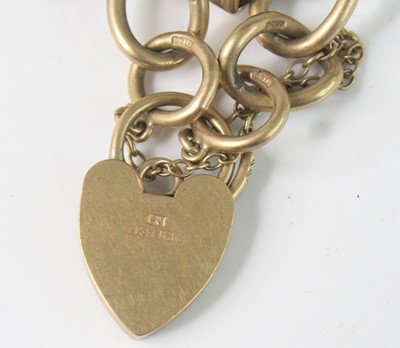 Lot 2590 - A 9ct gold curblink charm bracelet, with heart...