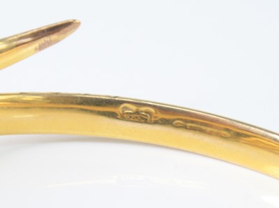 Lot 2591 - A yellow metal snake bangle, having finely...