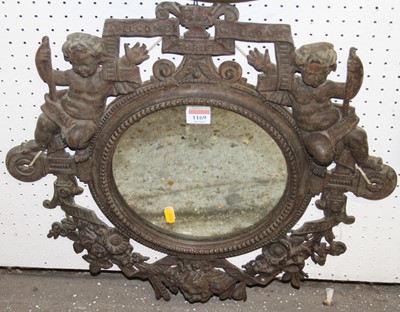 Lot 1169 - A cast iron framed circular wall mirror,...