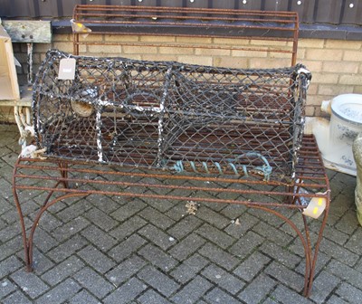 Lot 1173 - A rusted wrought iron two-seater garden bench,...