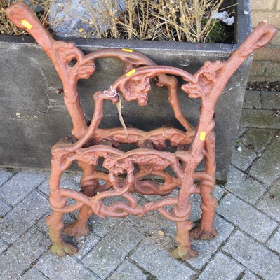 Lot 1175 - A pair of cast iron bench ends, in the manner...