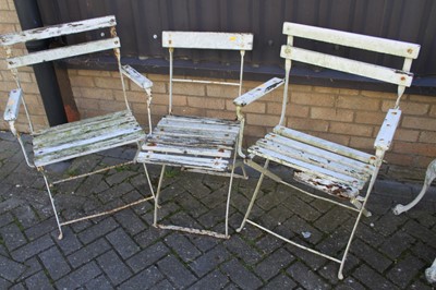 Lot 1180 - A pair of white painted iron and wood slatted...