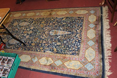 Lot 1185 - A Persian woollen blue ground rug, the heavily...