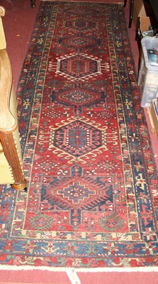 Lot 1189 - A Persian woollen red ground Shiraz hall...