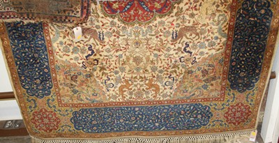 Lot 1192 - A Persian woollen cream ground Tabriz rug, 210...