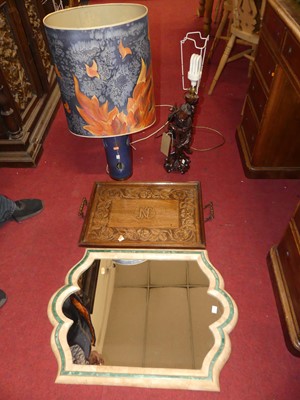 Lot 1342 - A shaped wall mirror; together with a relief...