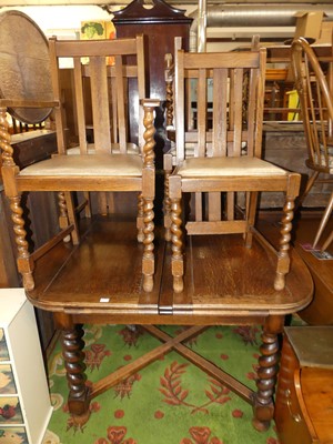 Lot 1378 - A 1930s barleytwist oak dining suite,...