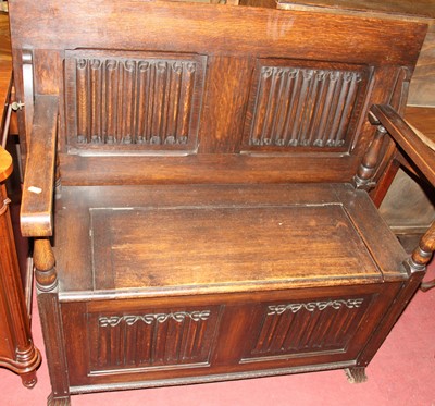Lot 1324 - An early 20th century linen fold oak twin...
