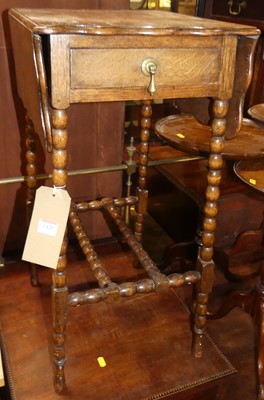 Lot 1426 - An early 20th century oak dropflap single...