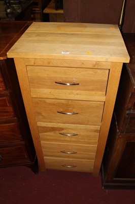 Lot 1427 - A contemporary light oak narrow chest of five...