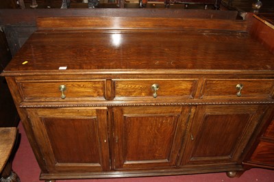 Lot 1431 - A 1930s oak ledgeback three door sideboard,...