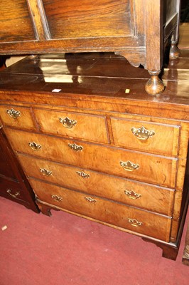 Lot 1439 - An 18th century figured walnut chest of three...