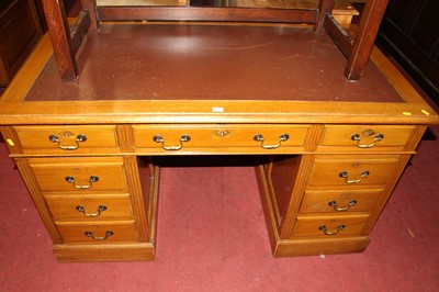 Lot 1449 - A walnut and tan rexine inset twin pedestal...