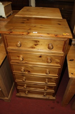 Lot 1456 - A modern varnished pine narrow chest of six...