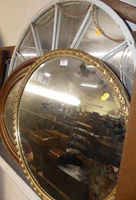 Lot 1011 - A gilt composition framed and bevelled oval...
