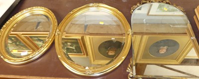 Lot 1037 - A gilt framed and bevelled oval wall mirror,...