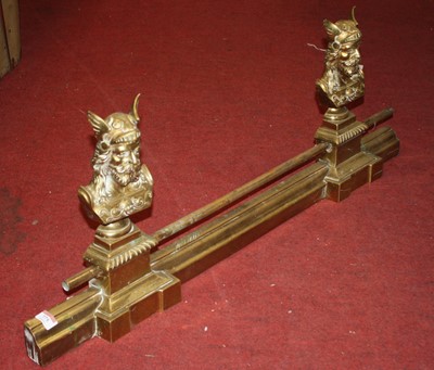Lot 775 - A brass fire fender decorated with busts of...