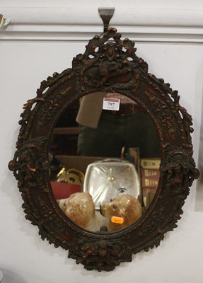 Lot 797 - A reproduction Chinese wall mirror, the oval...