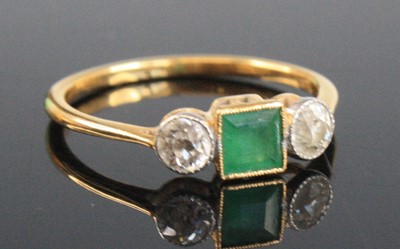 Lot 2665 - An 18ct gold, emerald and diamond three-stone...
