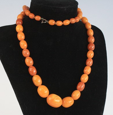 Lot 2685 - A butterscotch amber necklace, arranged as 55...