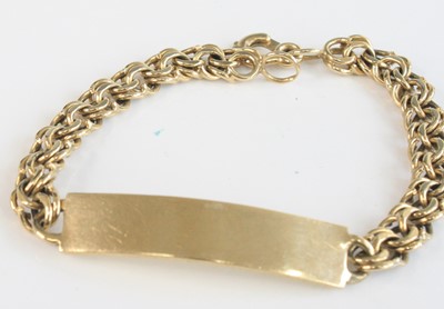 Lot 2689 - A modern 9ct gold identity bracelet, on double-...