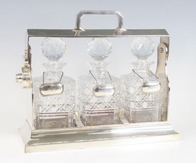 Lot 2120 - An Edwardian silverplated three-bottle...