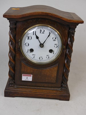 Lot 4 - An early 20th century oak cased mantel clock,...