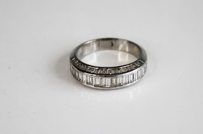 Lot 2265 - A white metal diamond half eternity ring,...