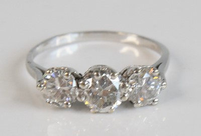 Lot 2189 - A white metal diamond trilogy ring, featuring...