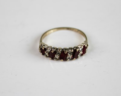 Lot 2143 - An 18ct white gold, ruby and diamond half hoop...