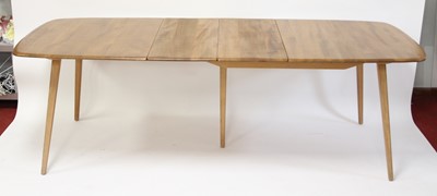 Lot 307 - A 1960s Ercol light elm extending dining table,...