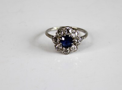 Lot 2165 - A white metal, sapphire and diamond circular...