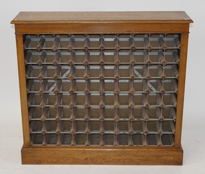 Lot 1537 - An oak 80 bottle capacity wine rack, w.107cm,...