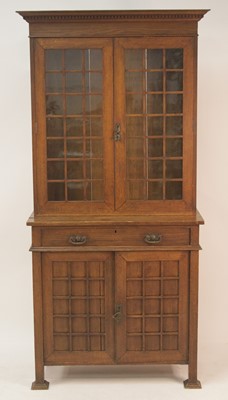 Lot 260 - An Arts & Crafts oak bookcase cupboard, having...