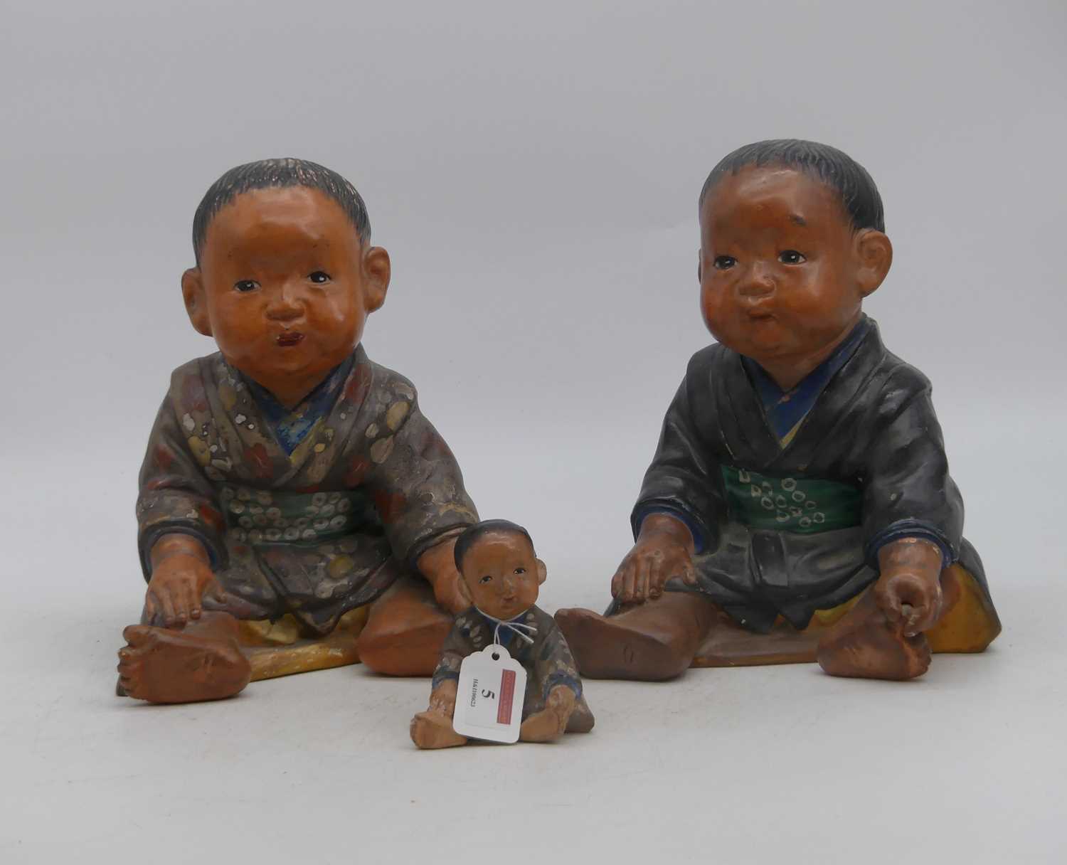 Lot 5 - A pair of painted plaster figures of infants,...