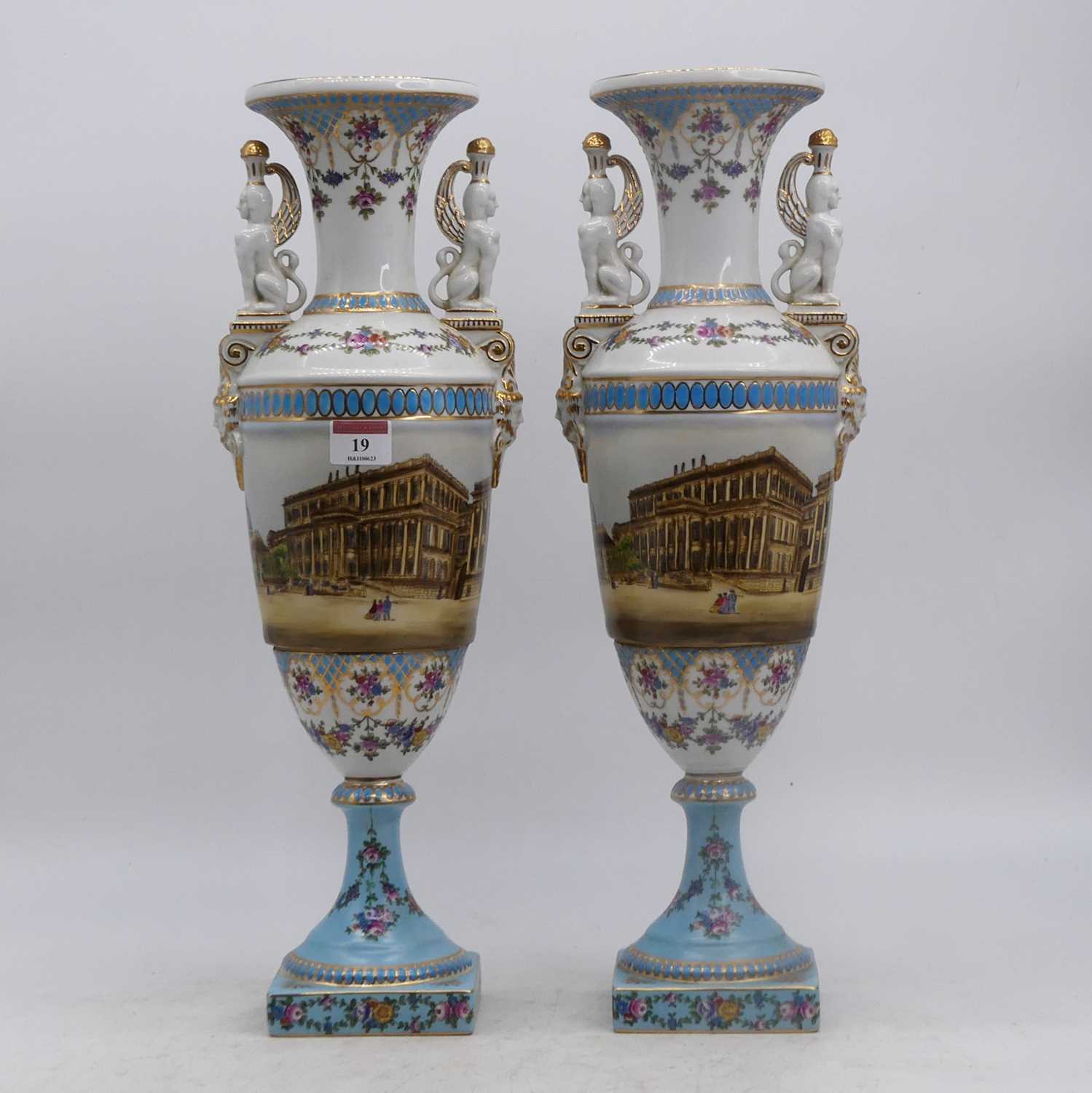 Lot 19 - A pair of porcelain vases, each flanked by...