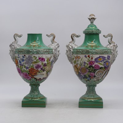 Lot 24 - A pair of porcelain urns, each flanked by...